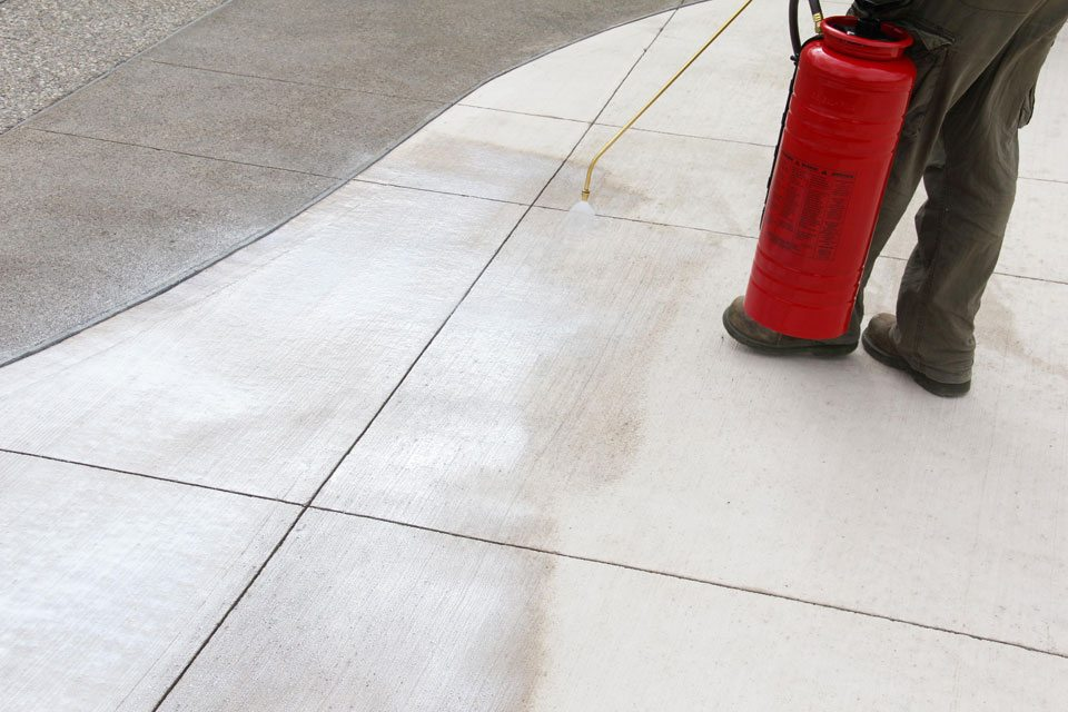 Professional concrete sealing service in progress